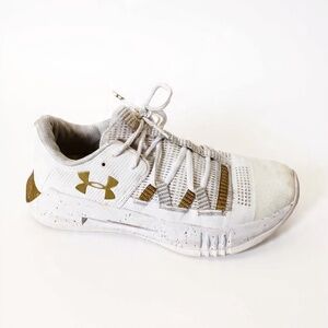 Under Armour White Sneakers with Gold Accents Size 10.